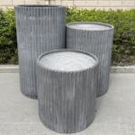 A trio of Fluted Garden Pots clustered together, showcasing their ribbed design.