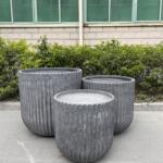 A trio of Fluted Garden Tubs clustered together, showcasing their ribbed design.