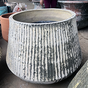 Thai limestone pots -- Fluted Torquelstone with vertical ribbing at Thomson's Garden Centre Orange NSW